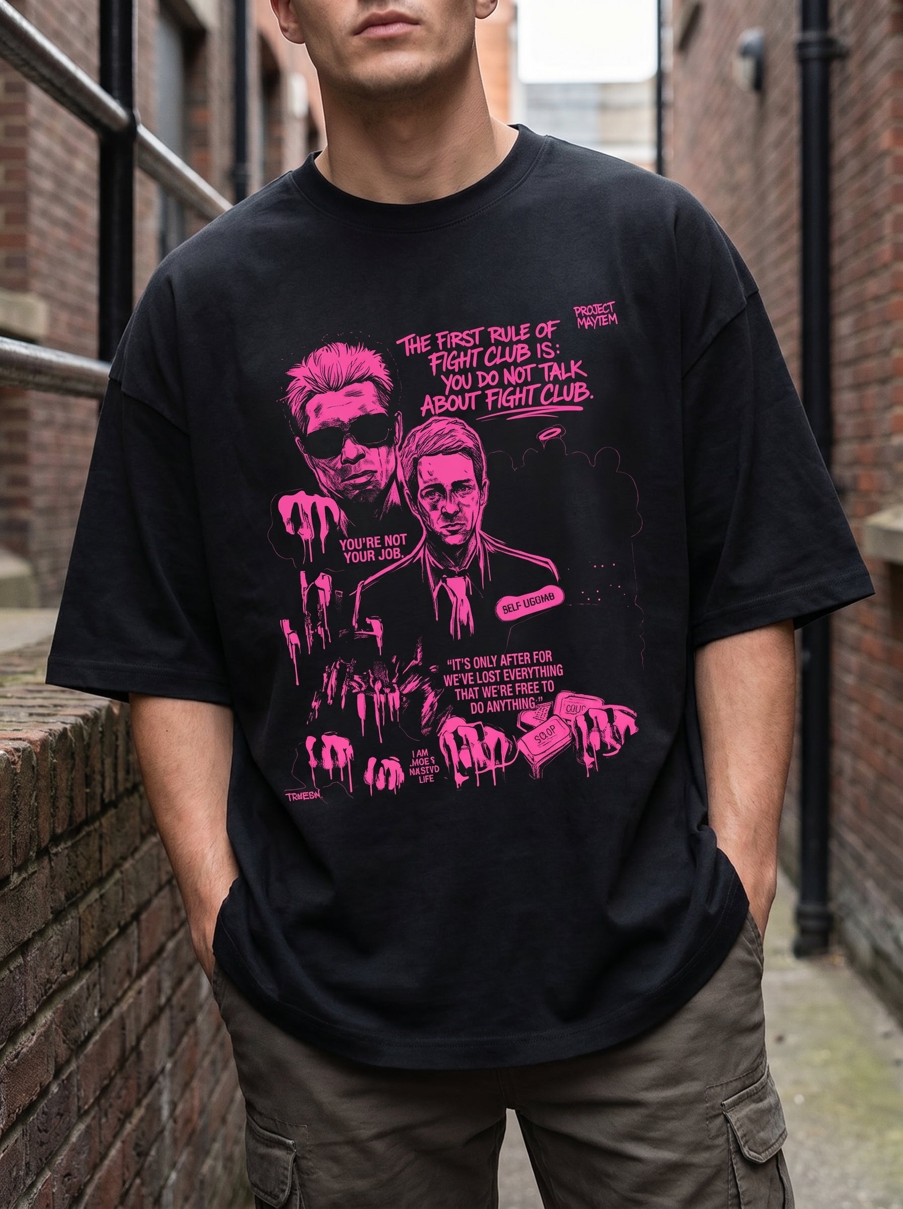 Male model wearing Culture Canvas Project Mayhem graphic tee — neon pink screen print on jet black oversized fit, urban street style