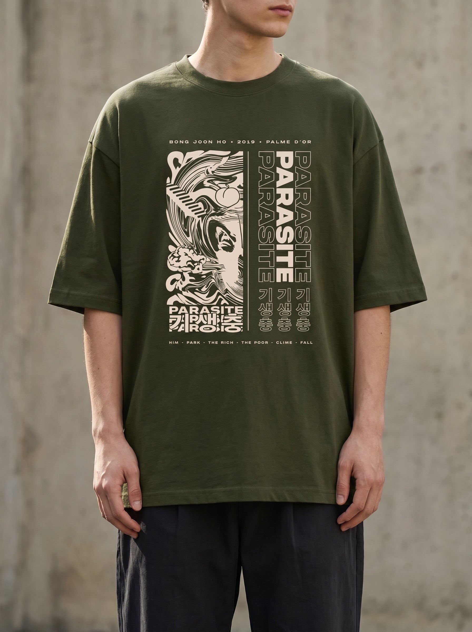 Male model wearing Culture Canvas Parasite tribute graphic tee in military olive green with Korean typography print