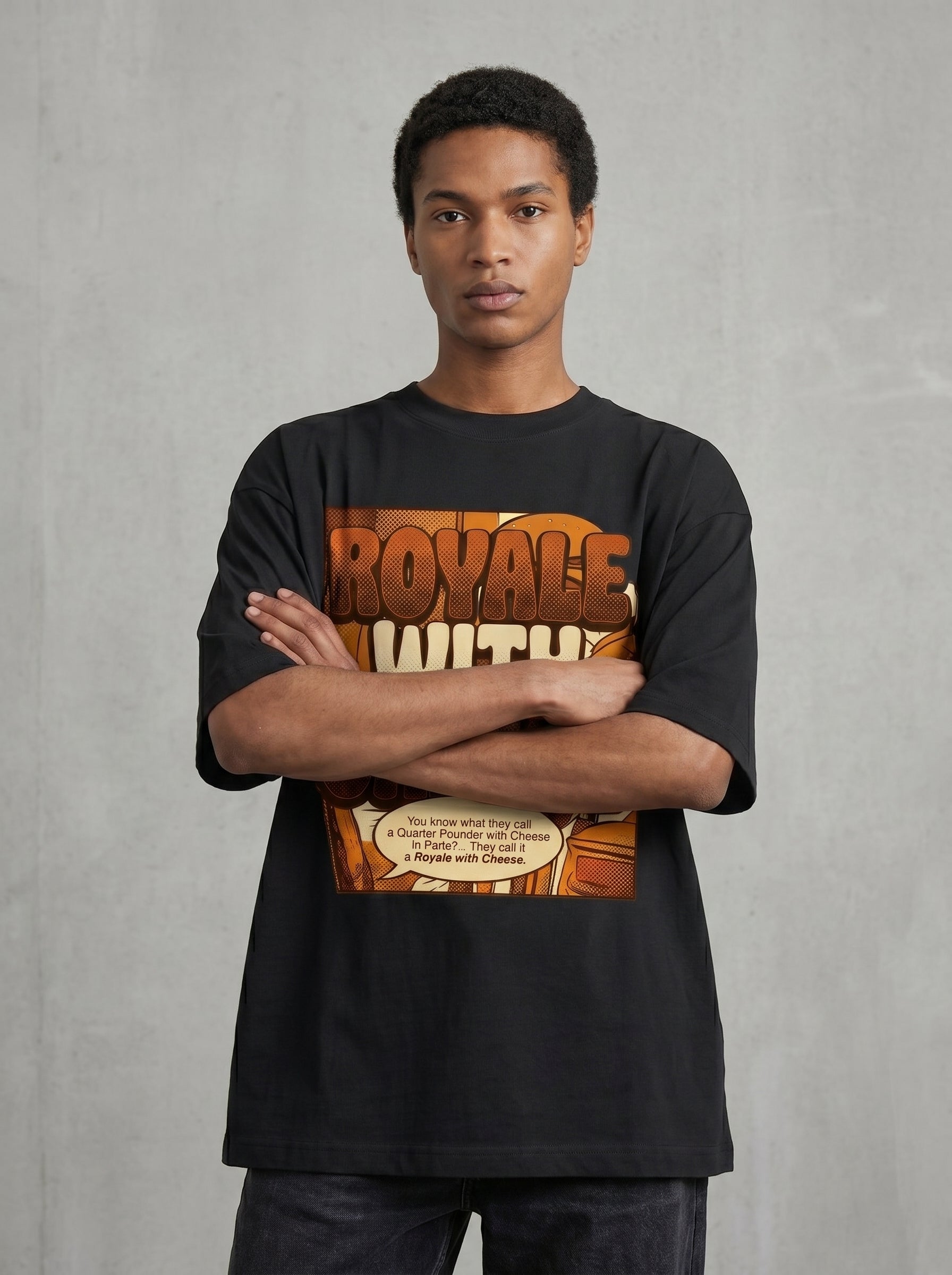 Male model wearing Culture Canvas Pulp Fiction tribute oversized tshirt — bold pop-art comic graphic in amber on jet black, unisex boxy fit